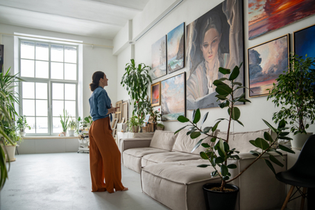 An array of artworks on a wall in a studio